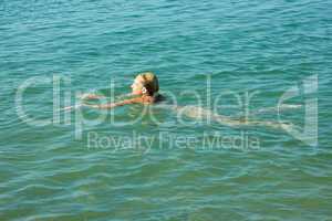 teenage girl swimming in sea water
