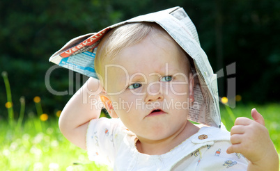 baby with paper on the summer meadow