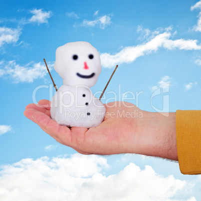 hand holding small snowman