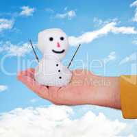 hand holding small snowman