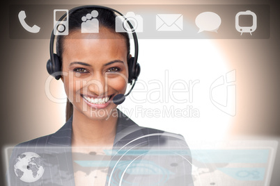 Beautiful ethnic businesswoman with a headset on smiling at the