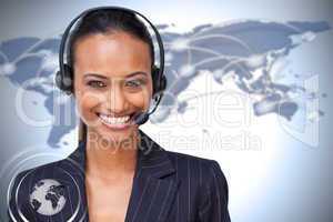 Beautiful ethnic businesswoman with a headset on smiling at the