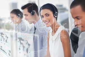 Smiling agent with colleagues sitting