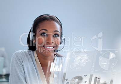 Delighted businesswoman using headset at her desk