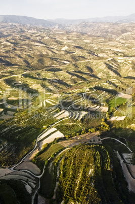 aerial view at farm fields in front of misty mountains
