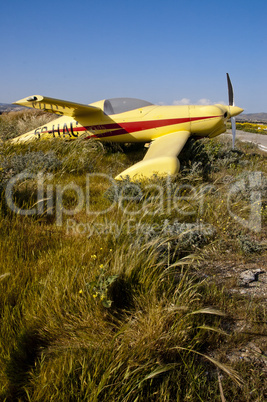 small airplane parked in grass