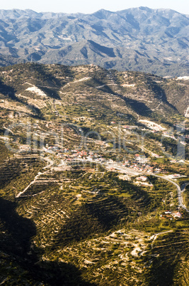 aerial view at farm fields in front of misty mountains