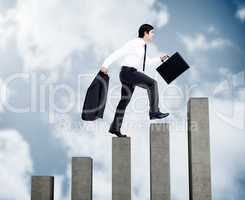 Young businessman climbing grey steps