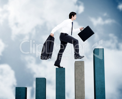 Young businessman climbing grey and blue steps