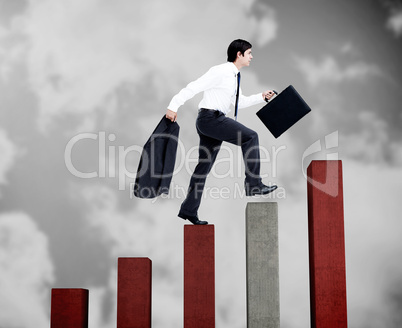 Young businessman climbing grey and red steps