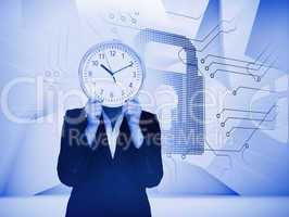 Businesswoman hiding face with clock