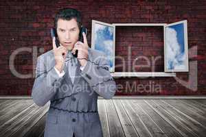 Serious businessman wrapped in cables phoning