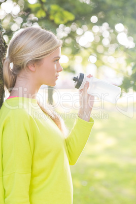 Fit calm blonde holding water bottle