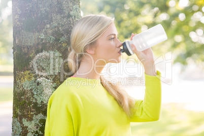 Fit peaceful blonde drinking from water bottle