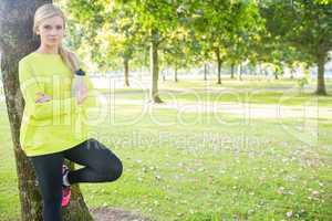 Fit happy blonde holding sports bottle