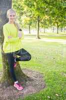 Fit cheerful blonde holding sports bottle