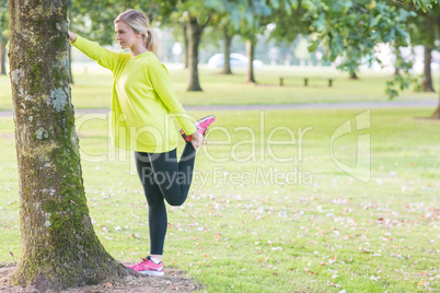 Fit beautiful blonde stretching leg