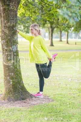 Fit pretty blonde stretching leg