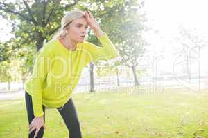 Active exhausted blonde pausing after running