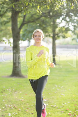 Active happy blonde jogging towards camera