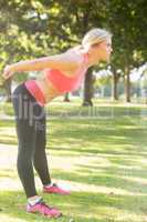 Active serious blonde stretching her body