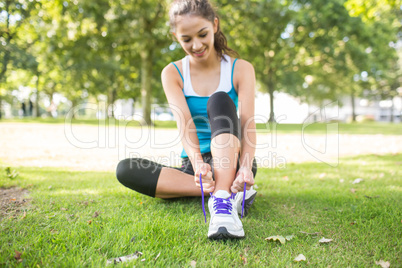 Active content brunette tying her shoelaces