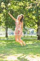 Stylish cheerful brunette jumping in the air