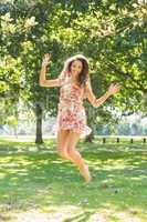Stylish happy brunette jumping in the air