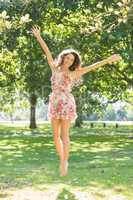 Stylish smiling brunette jumping in the air