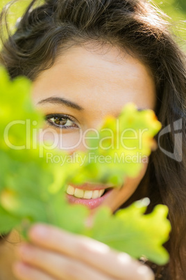 Gorgeous content brunette holding a leaf