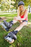 Casual gorgeous blonde wearing roller blades and helmet