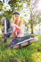 Casual pretty blonde wearing roller blades and helmet