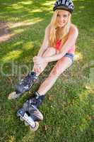 Casual content blonde wearing roller blades and helmet