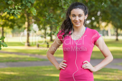 Content young woman posing in a park