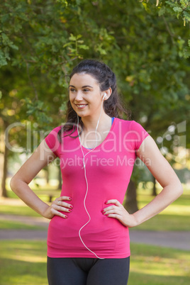 Sporty cute woman wearing sportswear posing in a park