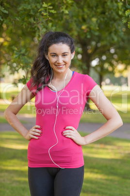 Happy young woman wearing sportswear posing in a park