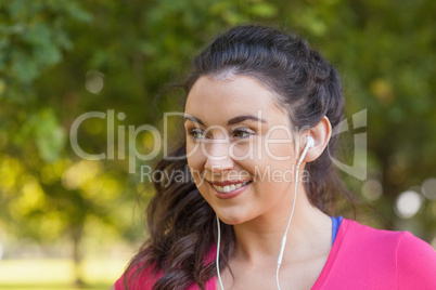 Cheerful cute woman listening to music