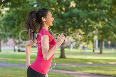 Pretty sporty woman jogging in a park