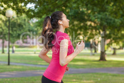 Serious sporty woman jogging in a park