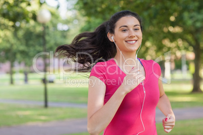 Sporty pretty woman jogging in a park