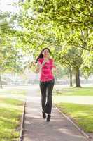 Gorgeous sporty woman jogging in a park