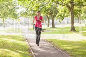 Sporty woman running in a park