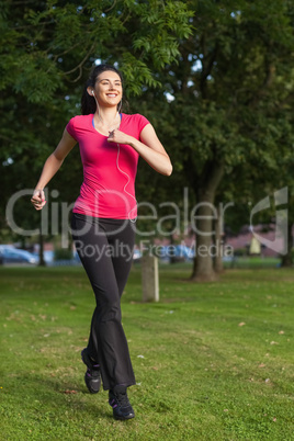 Happy woman running in a green park