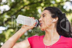 Sporty woman drinking out of a bottle