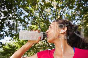 Content sporty woman drinking some water
