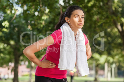 Pretty sporty woman having a break from running