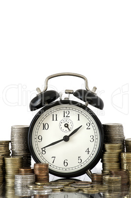 time is money concept: alarm clock and lots of euro coins