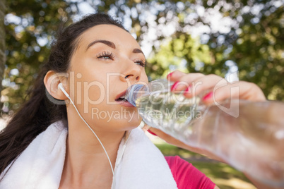 Sporty woman drinking water out of a bottle