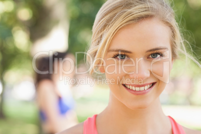 Gorgeous young blonde woman posing in a park