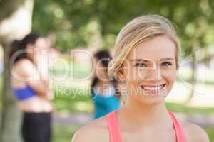 Beautiful blonde sporty woman posing in a park